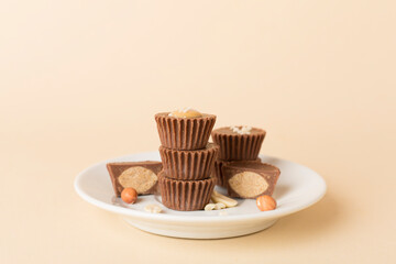 Tasty chocolate peanut butter cups on color background