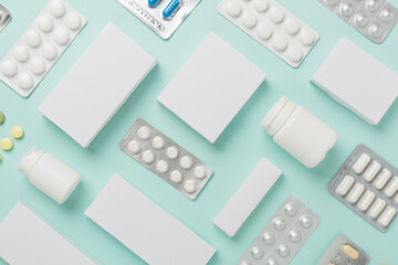 Flat lay with different pills in blister packaging and boxes and on color background - obrazy, fototapety, plakaty