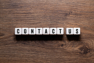 Contact us - word concept on building blocks, text