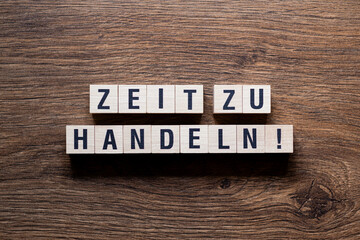 Zeit zu handeln - word concept on building blocks, text