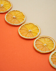 Dried orange slices on an orange background