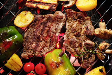 Assorted delicious grilled meat with vegetables on a grill