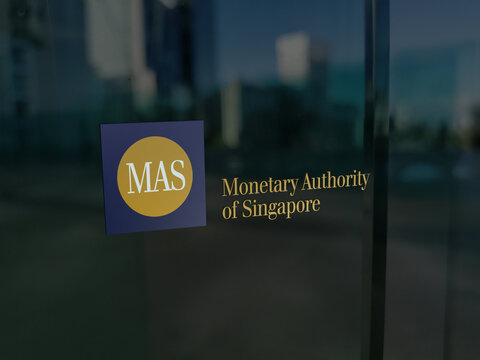 MAS logo, Monetary Authority of Singapour on the administrative desk window.
