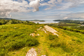 Eryri or Snowdonia heathland looking toward river estuary. - 679860159