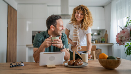 happy couple man and woman husband and wife morning routine use tablet - Powered by Adobe
