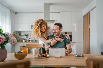 happy couple man and woman husband and wife morning routine use tablet