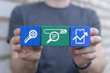 Man holding colorful blocks sees word: DOWNLOAD. Concept of Download Data Storage Business Web Technology. Downloading.