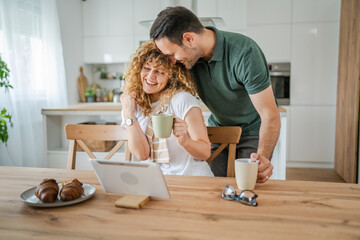 happy couple man and woman husband and wife morning routine use tablet