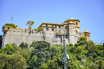 Panoramic view to the pier and colorful  apartments and Italian architecture of the see and the boat Portofino, Italy