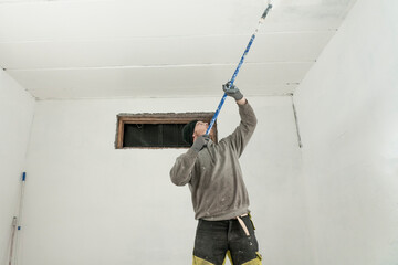 Skilled Artisan Painting Garage in Pristine White - Expert Home Improvement.