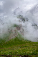 Julian Alps mountain Mangart from Mangrt saddle, Slovenia's Highest Panoramic Road, foggy weather