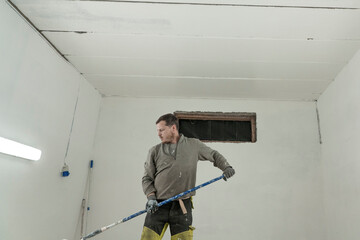 Skilled Artisan Painting Ceiling in Pristine White with Precision and Care.