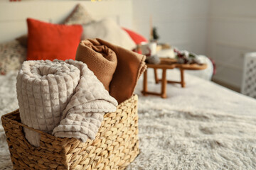 Wicker basket with cozy blankets, home mood