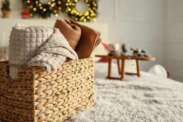 Wicker basket with cozy blankets, home mood
