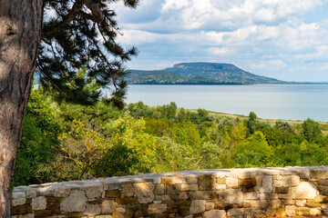 Summer Lake Balaton landscape with Badacsony Hill and clouds in the background