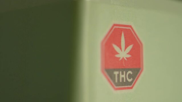 Macro close up of THC warning on the CBD box. CBD or cannabidiol made of Marijuana weed plant and have analgesic pain-relieving properties. CBD may provide relief for various types of pain.