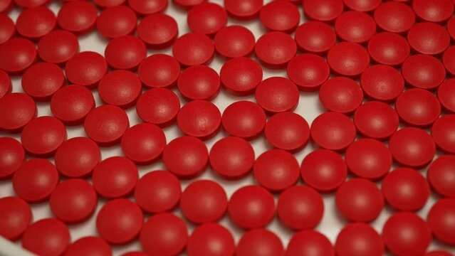 Medical pills factory, pharma industry and manufacturing concepts. Slow rotation of red pills. National Opioid Awareness Day.