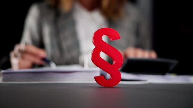 Judicial Tax Lawyer at Desk with Red Calculator