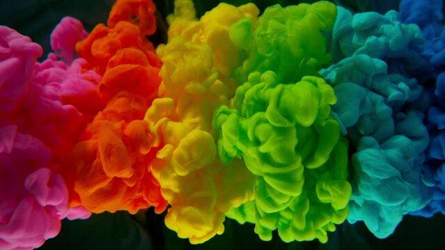 Abstract background, colorful liquid pouring isolated on black background, super slow motion filmed on high speed cinema camera at 1000 fps