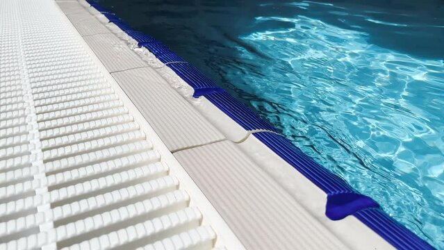 The calm splash of water against the side of the overflow pool