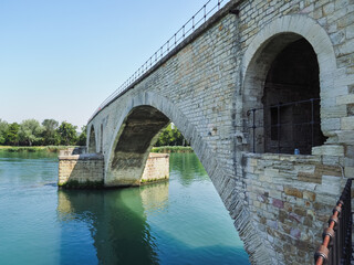 River Rhone and 12th-century bridge close up. Ruins of famous medieval Saint-Benezet bridge, also...