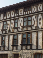 Traditional medieval French architecture in the Carcassonne, France. Ornate abandoned building with typical mansard roof and windows.
