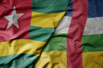 Obraz premium big waving national colorful flag of central african republic and national flag of togo .
