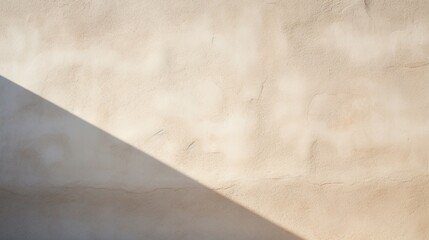 A close-up view of a stucco-textured exterior wall with rough, earthy texture, capturing the interplay of light and shadows on its surface.