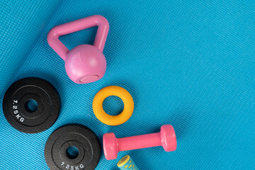 close up exercising sport equipment on the blue yoga mat background, healthy and workout concept