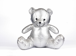 silver gray teddy bear toy on white background, congratulatory postcard or banner with the birth of a baby or birthday.