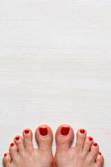 Beautiful woman's vinous burgundy nails with beautiful pedicure. Female feet with bright pedicure...