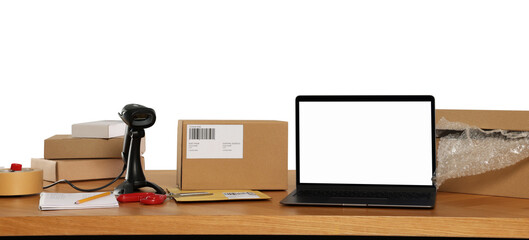 Parcels, laptop and barcode scanner on wooden table against white background. Online store