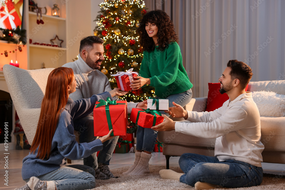 Canvas Prints Christmas celebration. Happy friends exchanging gifts at home