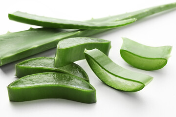 Fresh aloe vera pieces on white table