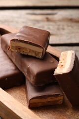 Tasty chocolate bars with nougat on table, closeup