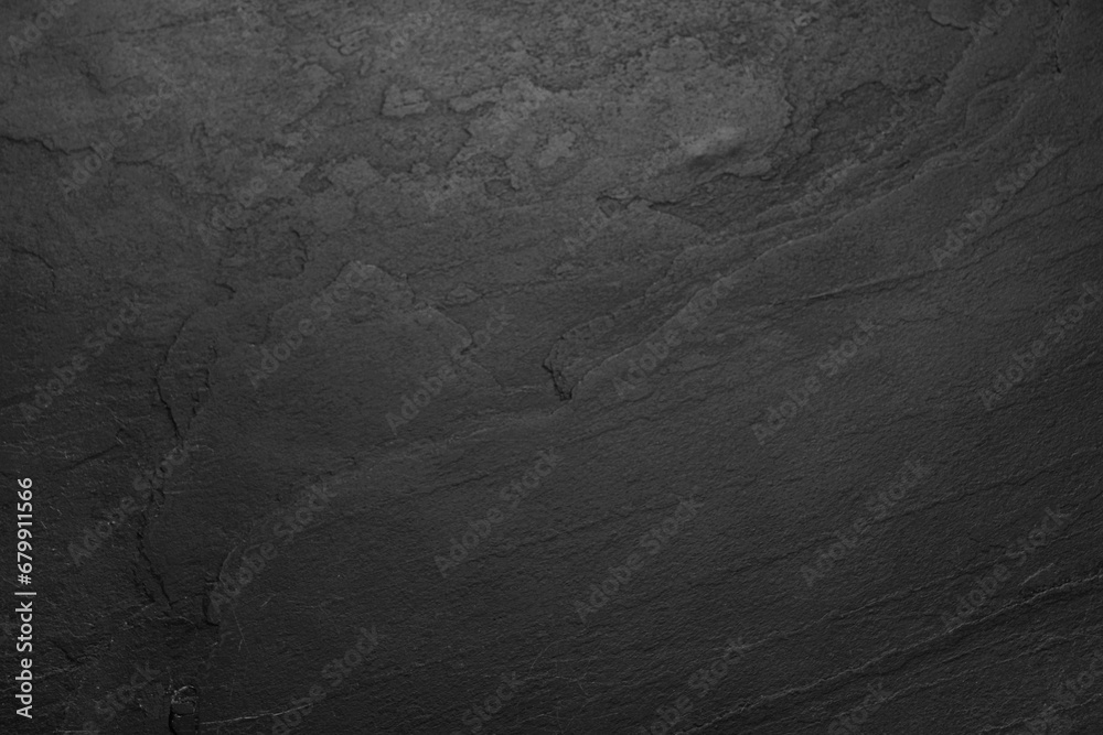 Sticker texture of black stone surface as background, closeup