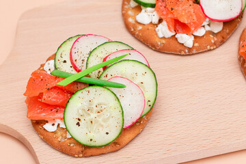 Crispy Cracker Sandwiches with Fresh Salmon, Cucumber, Radish, Cottage Cheese and Green Onions. Easy Breakfast. Quick and Healthy Sandwiches. Crispbread with Tasty Filling. Healthy Dietary Snack