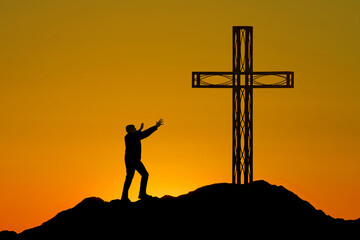 Man stands before a cross on a mountain - 679922753