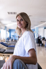 Side portrait of a middle aged blonde nurse in the hospital while working.