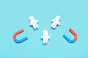 Magnets with group of customers on blue background. Marketing concept