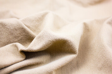 Crumpled beige fabric, folds of beige, brown fabric, textiles.