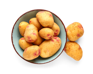 Bowl with fresh raw potatoes on white background