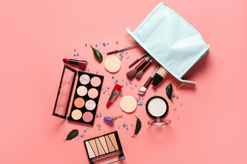 Stylish cosmetic bag with makeup products and beautiful flowers on coral background