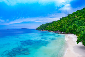 Aerial view of the beach and blue sea Nature of the beach and sea sunny summer With lush green forest