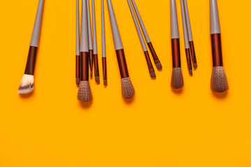 Makeup brushes on orange background
