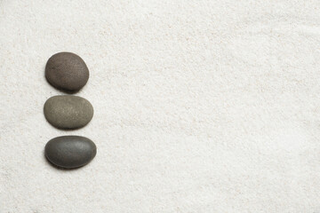 Fototapeta na wymiar Top view of three stones resting on sandstone balance concept, Japanese Zen garden.