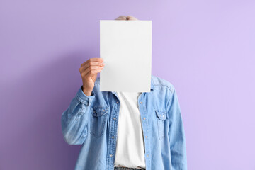 Mature woman with blank paper on lilac background