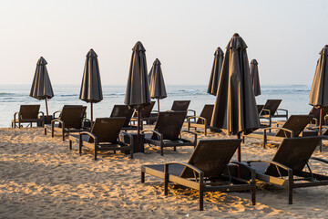 Public beach with lounge chairs and umbrellas