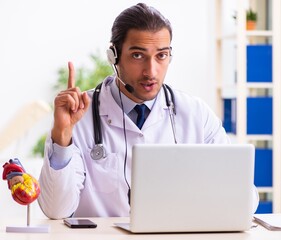 Young doctor listening to patient during telemedicine session