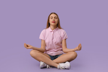 Beautiful young woman meditating on purple background. Zen concept